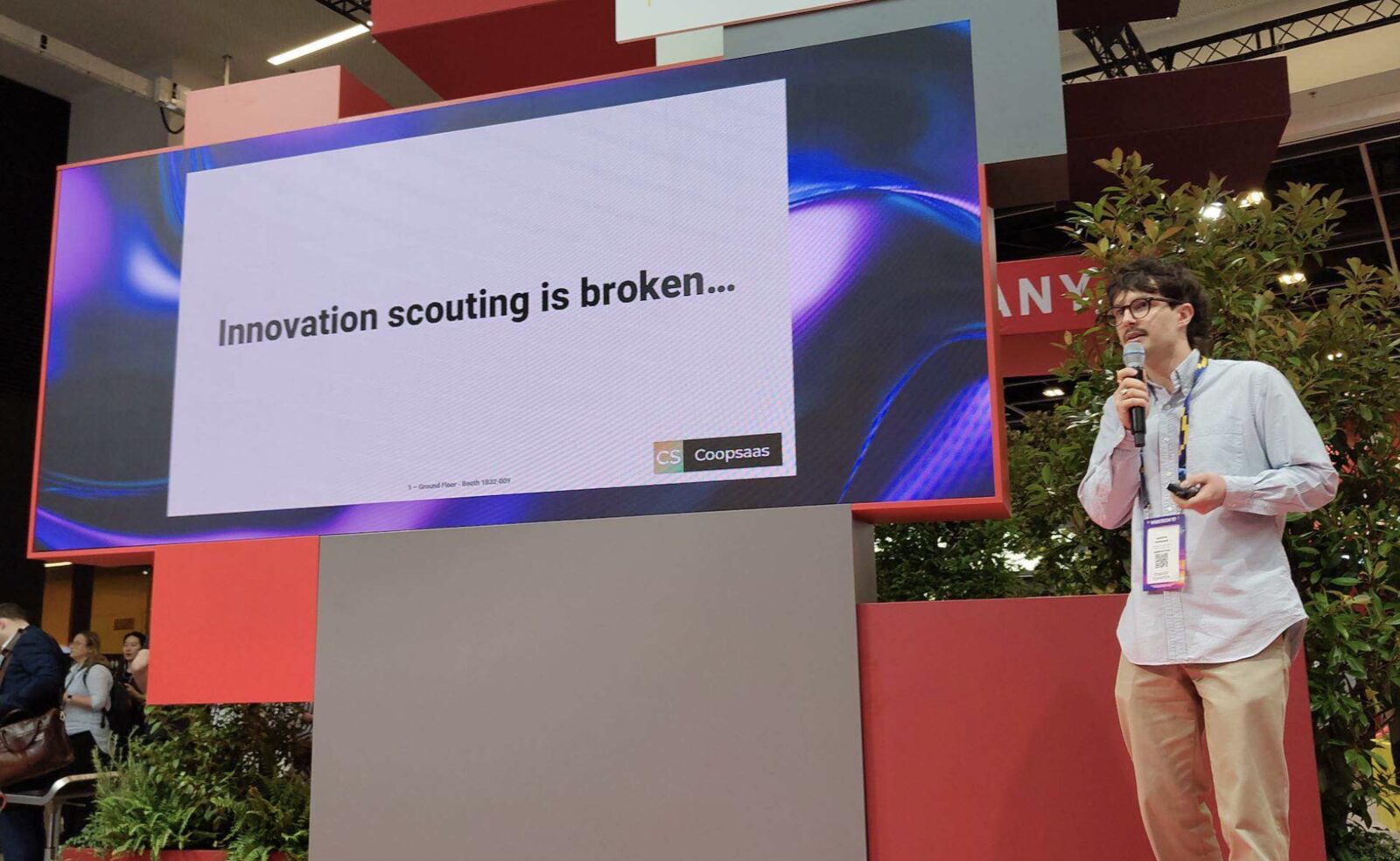 Quentin presenting Coopsaas on stage at VivaTech 2026, beside a slide reading: Innovation scouting is broken.